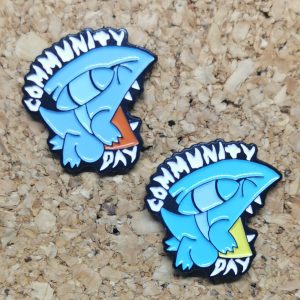 Both versions ofthe June 2021 Community Day Enamel Pin featuring normal and shiny Gible